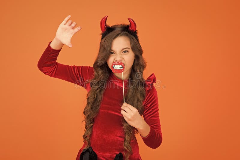 Vampire teeth. Little girl cute small horns celebrate Halloween. Carnival concept. Small child imp style accessory. Halloween party. Trick or treat concept