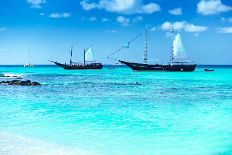 Arashi Beach, Aruba, West Indies: 2 tour boats anchored for tourists to go swimming or snorkeling in the turquoise water. Arashi Beach, Aruba, West Indies: 2 tour boats anchored for tourists to go swimming or snorkeling in the turquoise water.