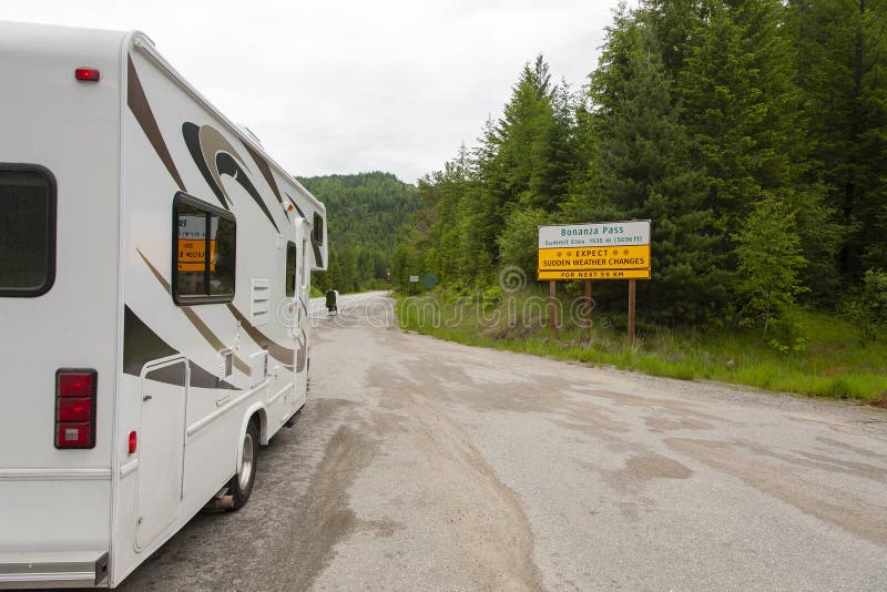 A white recreational van (RV) on the road captured at Bonanza Pass in Canada. A white recreational van (RV) on the road captured at Bonanza Pass in Canada