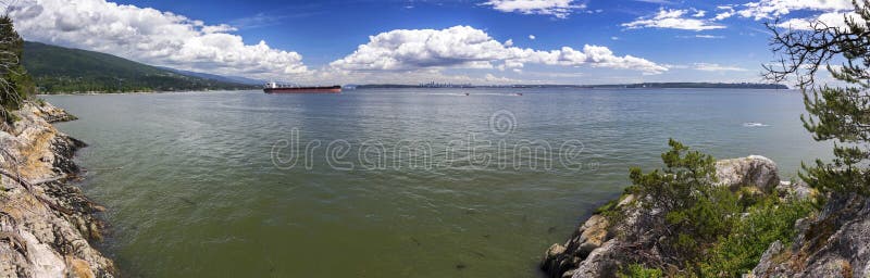 Vancouver BC Distant Skyline from Lighthouse Park at mouth of Burrard Strait. Wide Panoramic Landscape Scenic View of Burrard Strait and City of Vancouver royalty free stock photography Vancouver BC Distant Skyline from Lighthouse Park at mouth of Burrard Strait. Wide Panoramic Landscape Scenic View of Burrard Strait and City of Vancouver royalty free stock photography