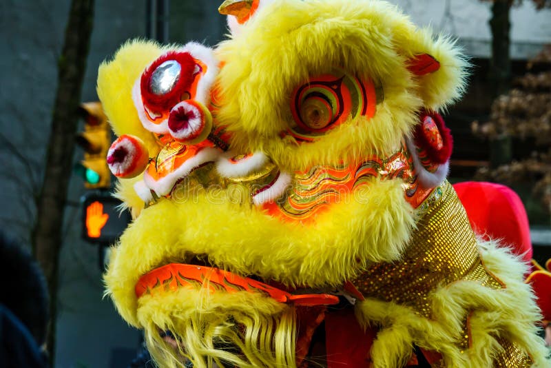 VANCOUVER, CANADA - February 18, 2014: People in Yellow Lion Costume at Chinese New Year parade in Vancouver Chinatown.