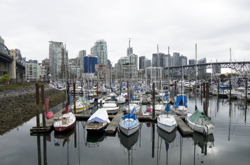 Nice modern apartments, boats and old bridges create an interesting image. Downtown Vancouver, Canada. Nice modern apartments, boats and old bridges create an interesting image. Downtown Vancouver, Canada.