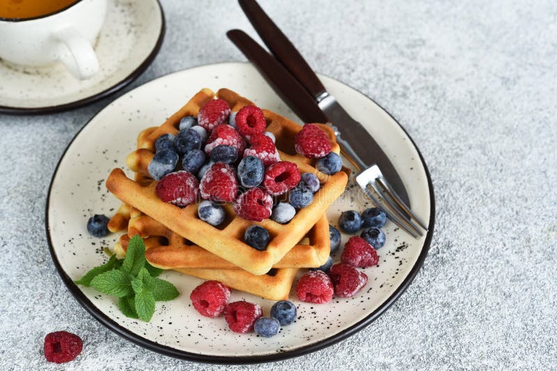 Vanilla Belgian Waffles with Berries and a Cup of Coffee for Breakfast
