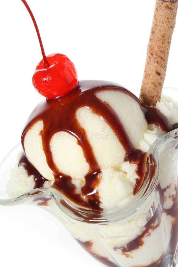 Delicious vanilla ice cream sundae dessert topped with chocolate sauce, wafer and maraschino cherry. Delicious vanilla ice cream sundae dessert topped with chocolate sauce, wafer and maraschino cherry