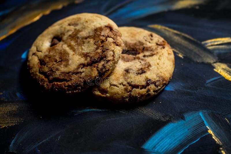 Vanilla Cookies with Chocolate Chips on a Blue and Gold Background
