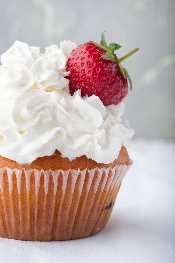 Vanilla Cupcake with White Frosting Whip Cream and a Strawberry Topper ...