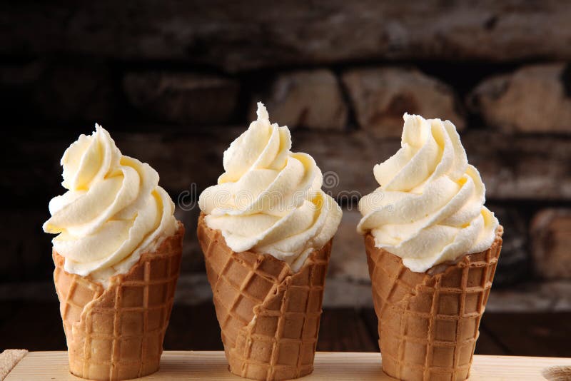 Vanilla frozen yogurt or soft ice cream in waffle cone.