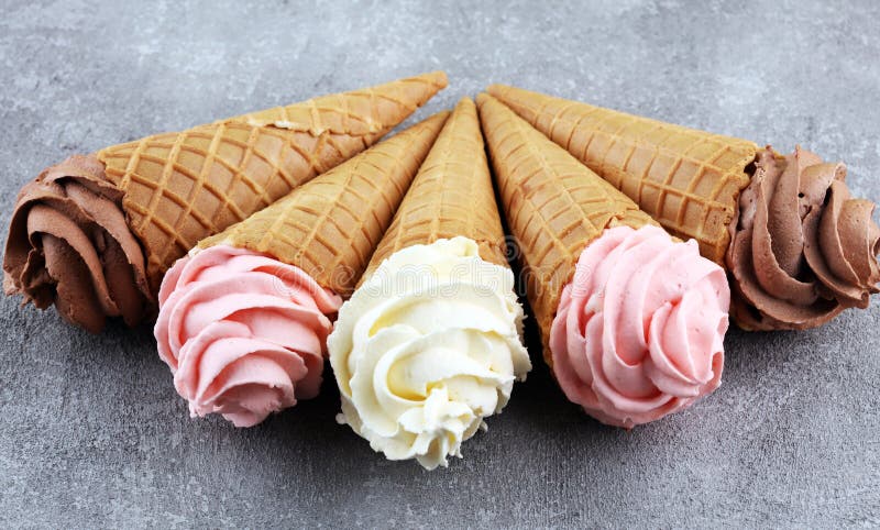 Vanilla frozen yogurt or soft ice cream in waffle cone.