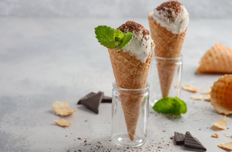 Vanilla Ice Cream in Waffle Cone with Chocolate Crumb on Grey Concrete