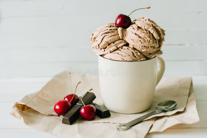 Vanilla sundae ice cream with sweet cherry and chocolate in cup