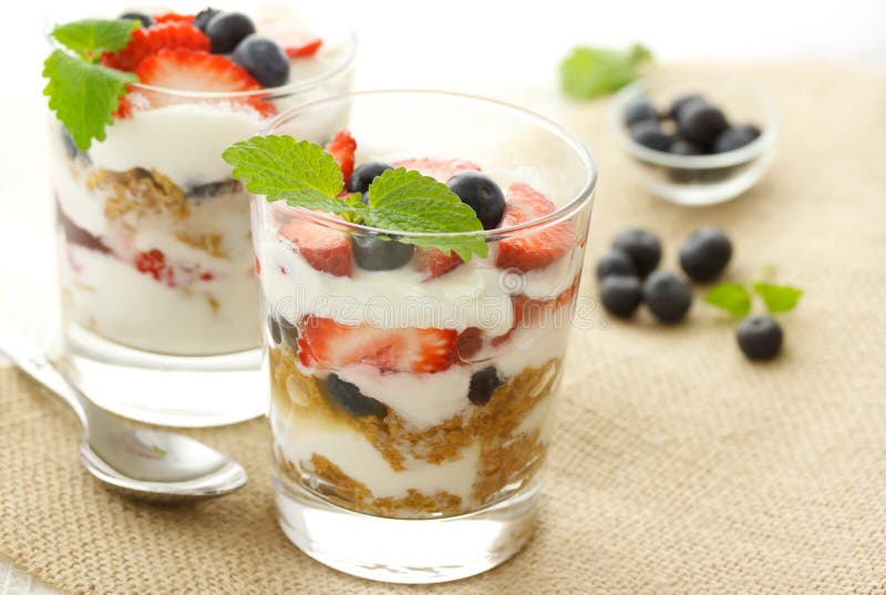 Vanilla yogurt over strawberries and blueberries