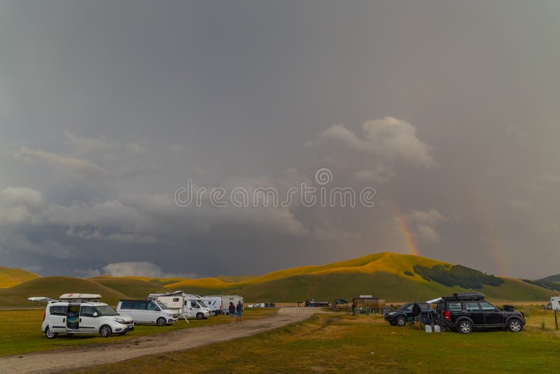 Vanlife in mountain landscape near Castelluccio village in National Park Monte Sibillini, Umbria region, Italy