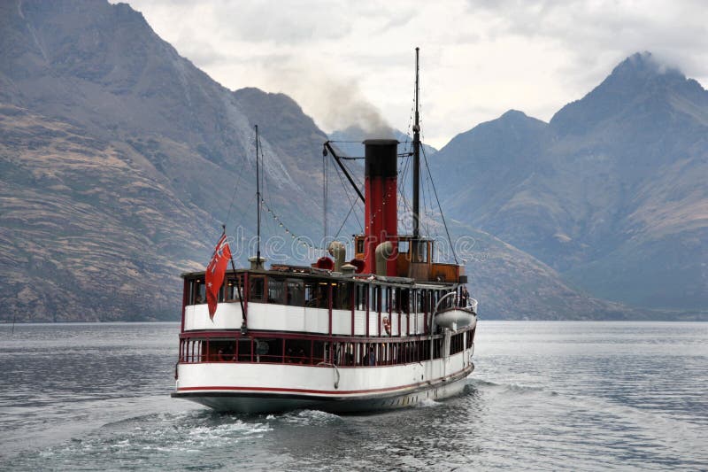 Vintage twin steamer - symbol of Lake Wakatipu and Queenstown in New Zealand. Rainy weather. Vintage twin steamer - symbol of Lake Wakatipu and Queenstown in New Zealand. Rainy weather.