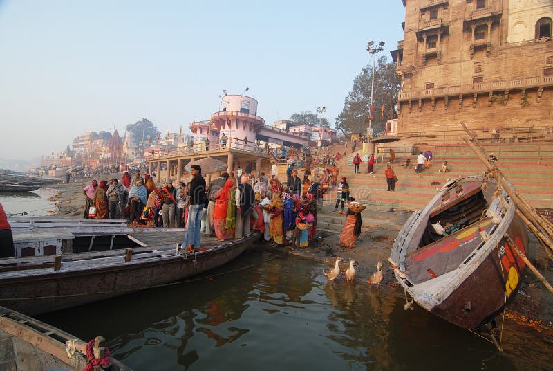 February 10,2012 Benaras,Uttar Pradesh,India,Asia- A group of Hindu pilgrimages gathering for rituals on the ghats of Ganges river at Benaras. February 10,2012 Benaras,Uttar Pradesh,India,Asia- A group of Hindu pilgrimages gathering for rituals on the ghats of Ganges river at Benaras.