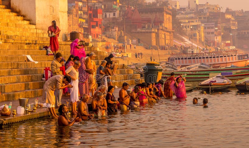 People pray at Ganges River. Varanasi, India - Mar 8, 2017. People bathing and offering prayers to the sacred river Ganges