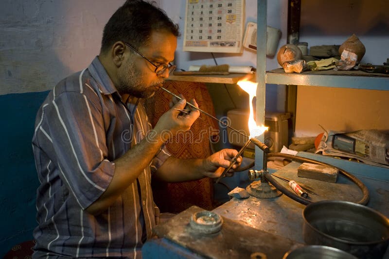 VARANASI, INDIA - MAY 15: Unidentified man working jeweler. stock photo VARANASI, INDIA - MAY 15: Unidentified man working jeweler. stock photo