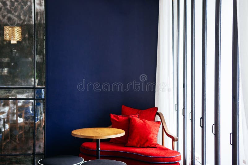 JUN 6, 2013 Chiang Mai, THAILAND - Living room with modern colorful couch, wooden table and lamp, natural light. JUN 6, 2013 Chiang Mai, THAILAND - Living room with modern colorful couch, wooden table and lamp, natural light