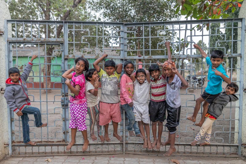 Vari village, Maharashtra, India -January 9, 2018: lovely kinds and their cottages. Daily life in Indian villages near Godavari ri stock photo Vari village, Maharashtra, India -January 9, 2018: lovely kinds and their cottages. Daily life in Indian villages near Godavari ri stock photo