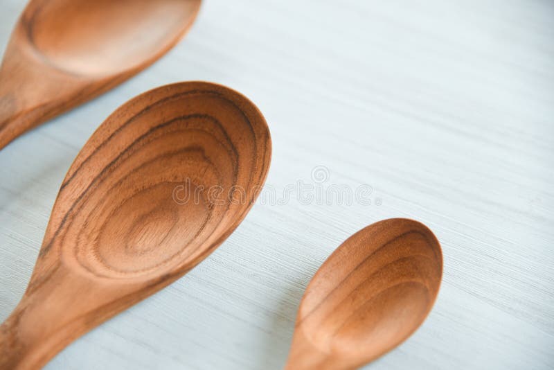 Zero waste kitchen use less plastic concept / Various sizes of wooden spoon and wooden cooked rice ladle on white background. Zero waste kitchen use less plastic concept / Various sizes of wooden spoon and wooden cooked rice ladle on white background