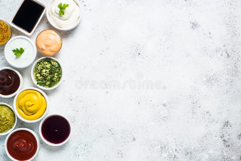 Set of sauces - ketchup, mayonnaise, mustard soy sauce, bbq sauce, pesto, chimichurri, mustard grains and pomegranate sauce on white background. Set of sauces - ketchup, mayonnaise, mustard soy sauce, bbq sauce, pesto, chimichurri, mustard grains and pomegranate sauce on white background.