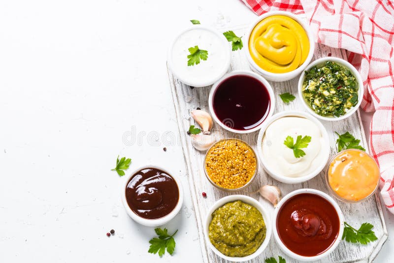 Set of sauces - ketchup, mayonnaise, mustard soy sauce, bbq sauce, pesto, chimichurri, mustard grains and pomegranate sauce on white background. Set of sauces - ketchup, mayonnaise, mustard soy sauce, bbq sauce, pesto, chimichurri, mustard grains and pomegranate sauce on white background.