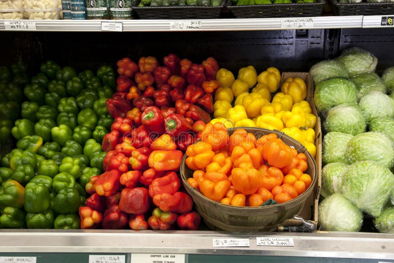 Variety of Bell Peppers on Display for Sale in Market Stock Photo