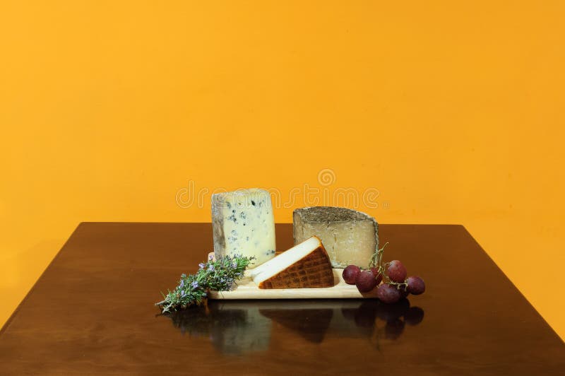 Variety Cheese Board, Grapes,fig and Bread Sticks on Rustic Wooden
