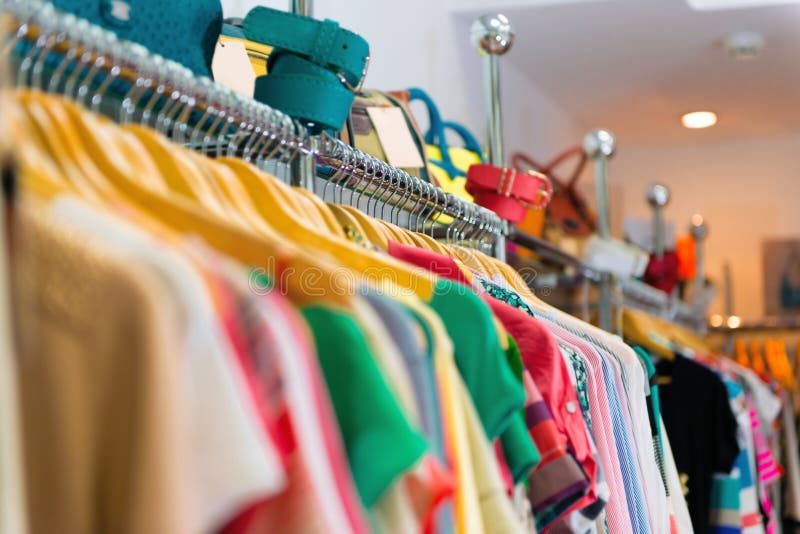 Variety of clothes hanging on rack stock photography