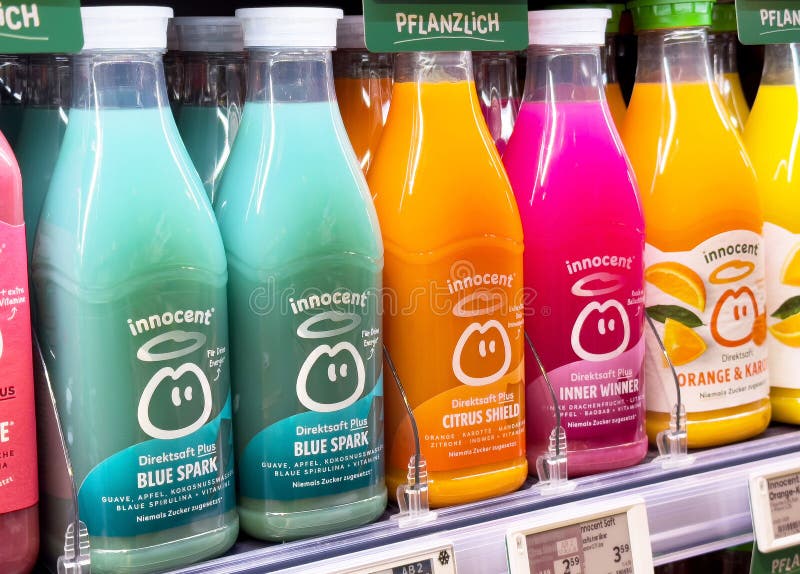 Variety of flavored fruit juices on store shelf, lifestyle