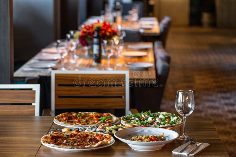 A Variety of Food on the Table in a Restaurant Made of Pizza, Sushi. on a  Blurred Background of the Restaurant. Stock Image - Image of closeup, meal:  156234739