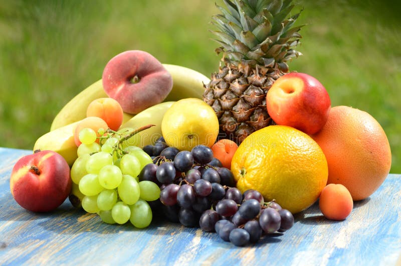 Variety of fruits on table in the garden