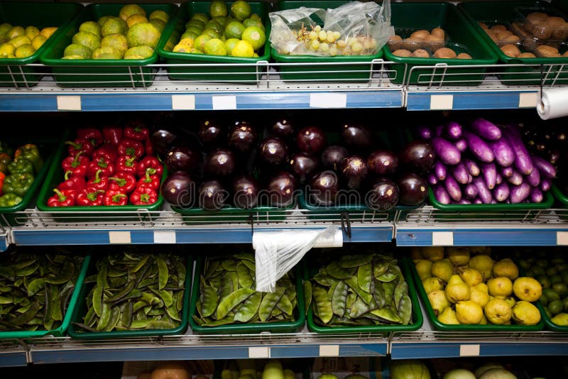 Variety of Fruits and Vegetables on Display in Grocery Store Stock