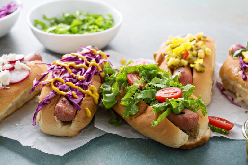 Variety of hot dogs with healthy garnishes