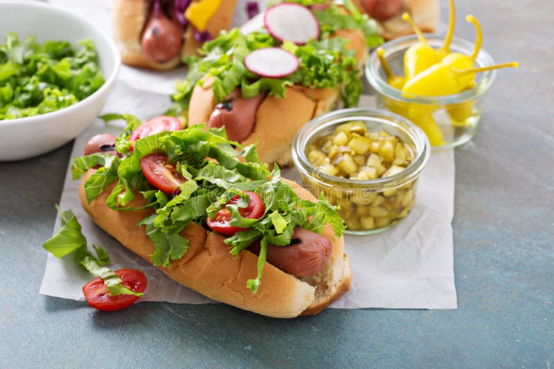Variety of hot dogs with healthy garnishes