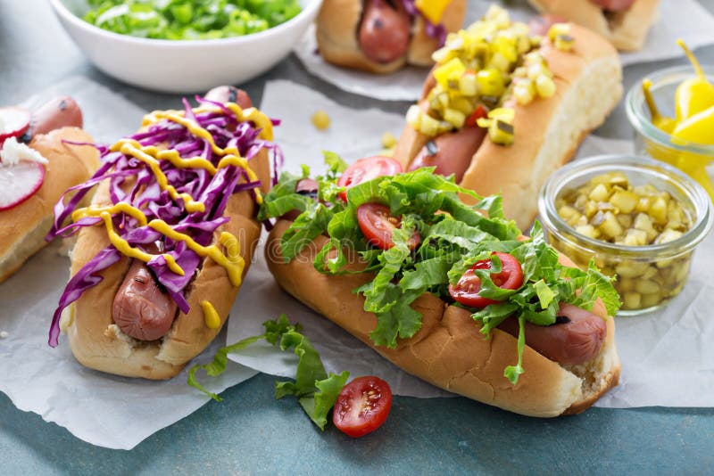 Variety of hot dogs with healthy garnishes