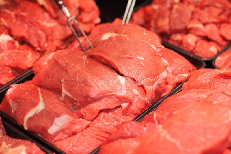 Variety of meat slices in boxes in supermarket