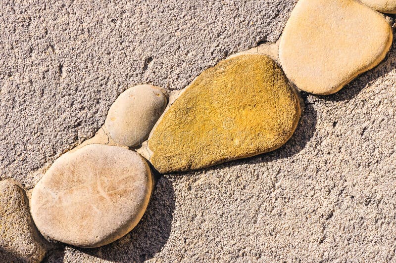 Variety of Stones, Cemented To Decorate a Concrete Wall Stock Image