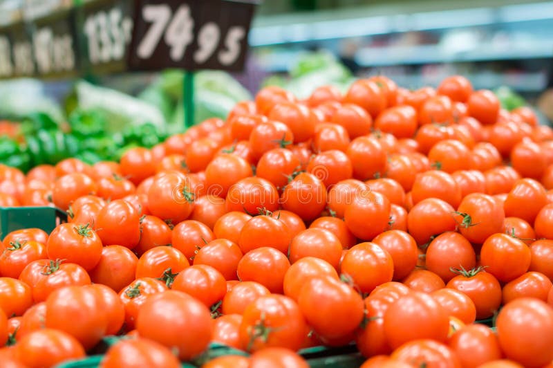 Variety of tomatoes in black boxes in supermarket royalty free stock photos