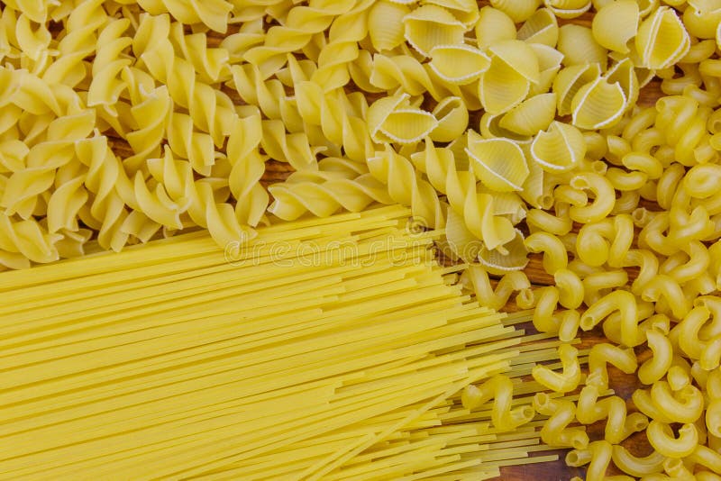 Variety of types and shapes of raw italian pasta. Close-up stock photo