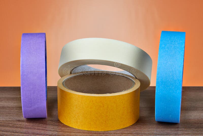 Varios rollos multicolores de la cinta adhesiva en un backgr anaranjado fotos de archivo libres de regalías Varios rollos multicolores de la cinta adhesiva en un backgr anaranjado fotos de archivo libres de regalías
