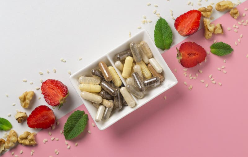 Various Capsules with Dietary Supplements, Ingredients and a Notebook