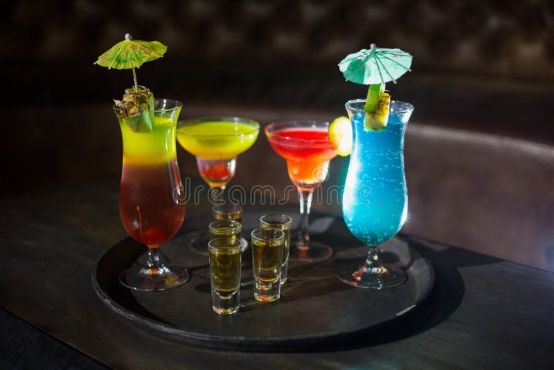 Various Cocktail Drinks and Shot Glasses of Tequila on Serving Tray