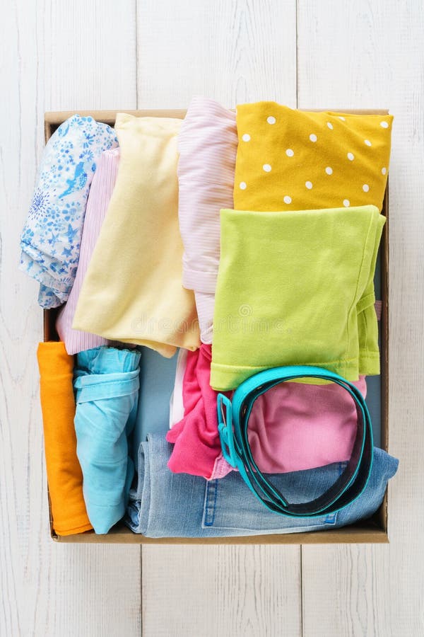 Various Colorful Clothes In A Box For Shipping Or Donation Stock Image ...