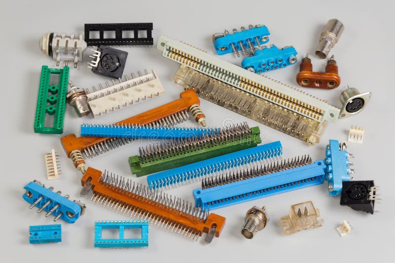 Various electrical connectors for different purposes on a gray surface stock photos
