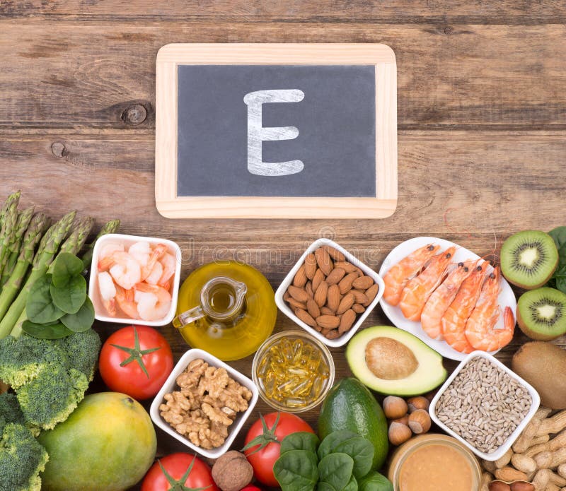 Vitamine E food sources, top view on wooden background