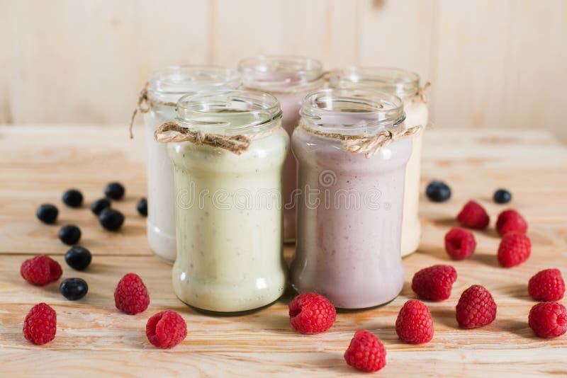 Various fresh berry milkshakes in glass jars stock images Various fresh berry milkshakes in glass jars stock images