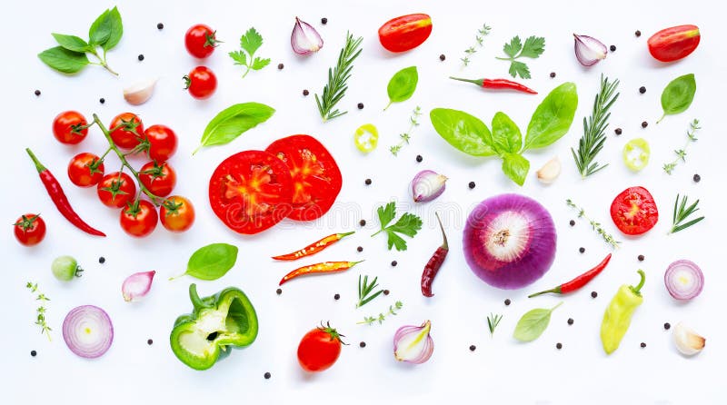 Various fresh vegetables and herbs on white