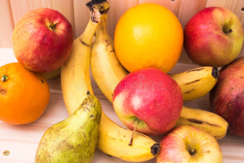 Various Fruits Apples Bananas Oranges Pomegranates On Natural Wooden