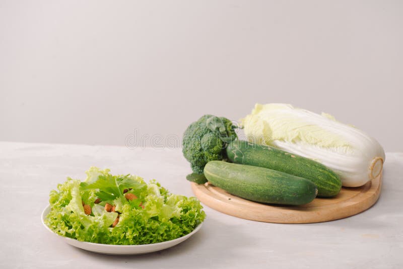 Various green organic salad ingredients on white background. Healthy lifestyle or detox diet food concept royalty free stock photography Various green organic salad ingredients on white background. Healthy lifestyle or detox diet food concept royalty free stock photography