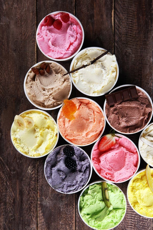 Various of ice cream flavor whit fresh blueberry, strawberry, kiwi, lemon, vanilla setup on rustic background . Summer and Sweet